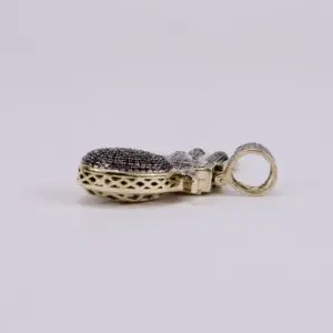 Gold and diamond pendant on side view.