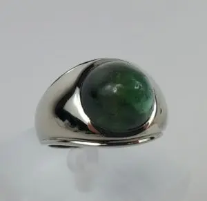 Silver ring with a green gemstone.