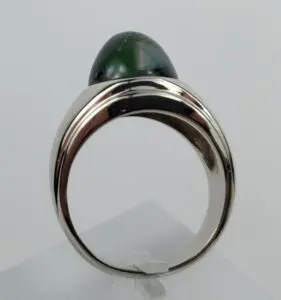 Silver ring with green gemstone cabochon.