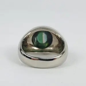 Silver ring with green gemstone inside.