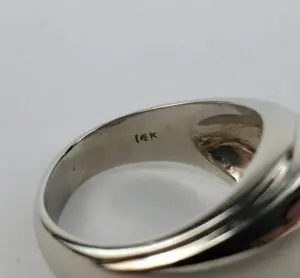 Silver ring with "14K" engraving inside.