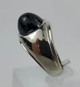 Silver ring with a black stone inset.