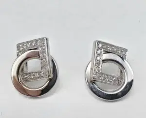 Diamond-studded geometric silver earrings.