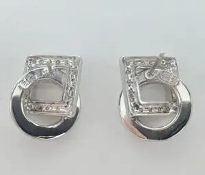 Silver geometric stud earrings on display.
