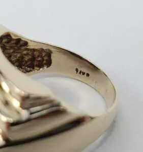 Gold ring with engraved inscription inside band.