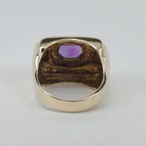 Gold ring with purple gemstone inside view.