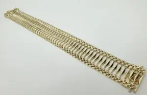 Gold bracelet with intricate link design.