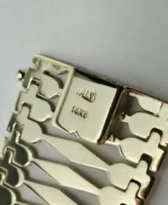 Gold bracelet clasp with "14K Italy" stamped.