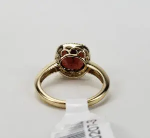 Gold ring with a red gemstone.