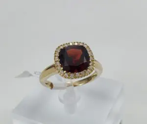 Gold ring with a large red gemstone.
