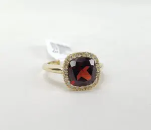 Gold ring with garnet and diamond accents.