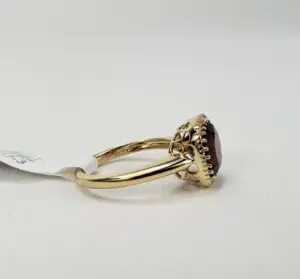 Gold ring with a red gemstone.