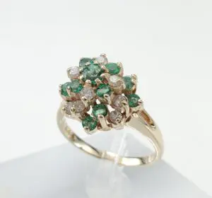Gold ring with emeralds and diamonds.