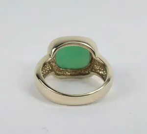 Gold ring with a green gemstone.