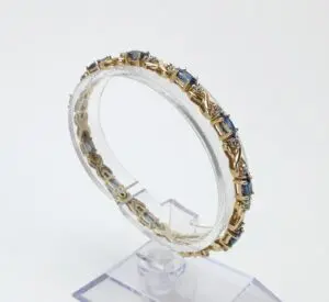 Gold bracelet with blue gemstone accents.