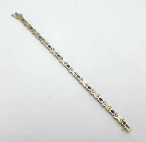 Gold bracelet with blue gemstone accents.