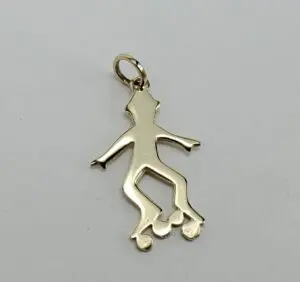 Gold skater pendant with roller skates.
