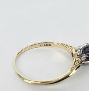 Gold ring with intricate side details.