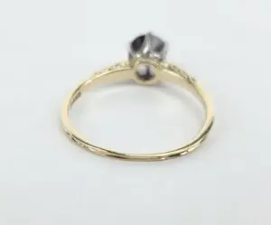 Gold ring with gemstone on white background.