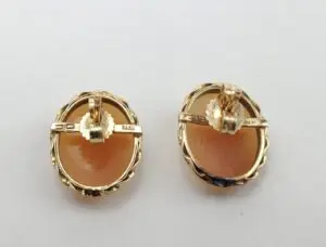 Gold oval clip-on earrings with stone.
