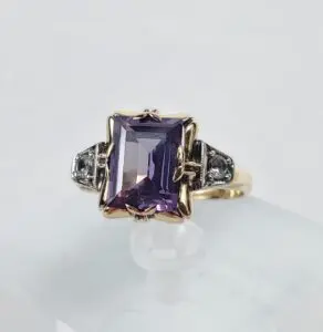 Purple gemstone ring with ornate silver accents.