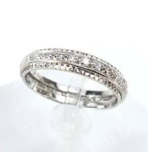 Silver diamond-patterned ring on display stand.