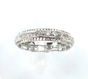 Silver diamond-studded ring on display stand.