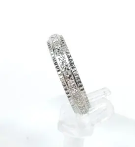 Silver ring with embedded diamonds on display.