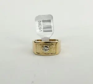 Gold ring with diamond and price tag.