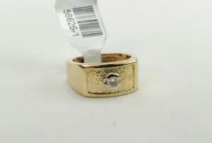 Gold ring with diamond and barcode tag.