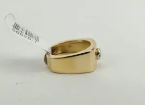 Gold ring with a price tag attached.