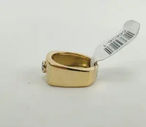 Gold ring with a barcode tag.