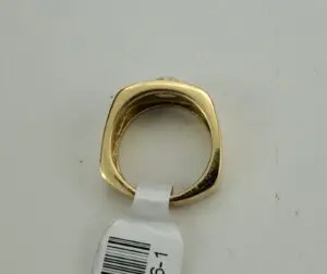 Gold ring with square band and tag.