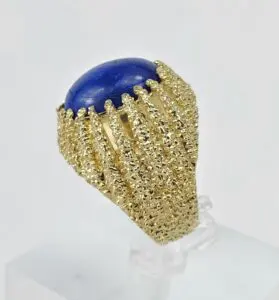 Gold ring with blue oval gemstone.