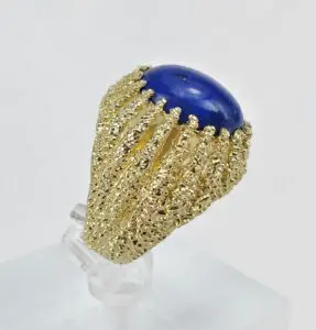 Gold ring with a blue gemstone centerpiece.