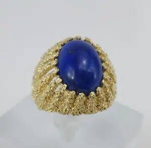 Gold ring with a blue gemstone centerpiece.