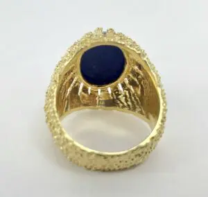 Gold ring with dark blue stone.