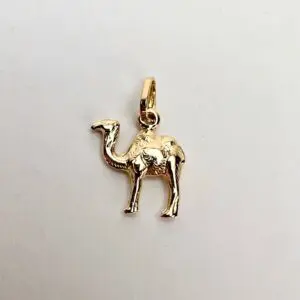 Gold camel-shaped pendant on white background.