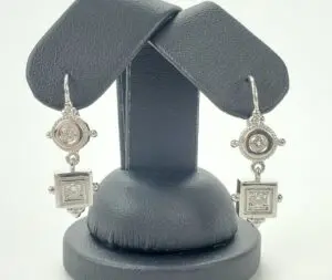 Silver drop earrings with geometric design.