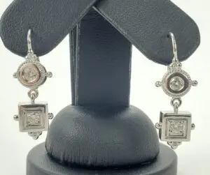 Silver earrings with square and round designs.