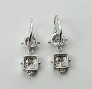 Silver square drop earrings on display.