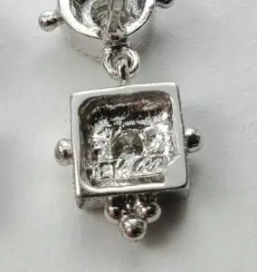 Silver jewelry piece with a gemstone detail.