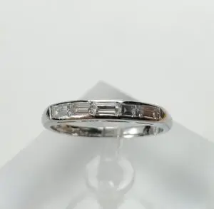 Silver ring with small rectangular diamonds.