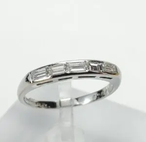 Silver ring with rectangular diamond accents.