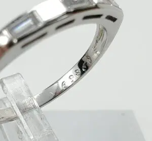 Silver ring with engraved numbers on display.