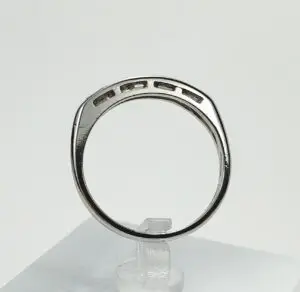 Silver ring with rectangular cutouts displayed upright.