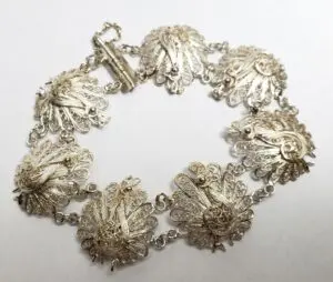 Silver filigree bracelet with peacock design.