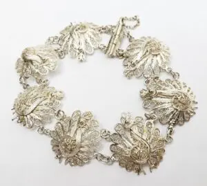 Intricate silver bracelet with floral designs.