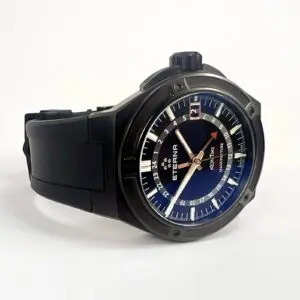 Black wristwatch with blue dial and date.