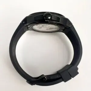 Black wristwatch with round face, side view.